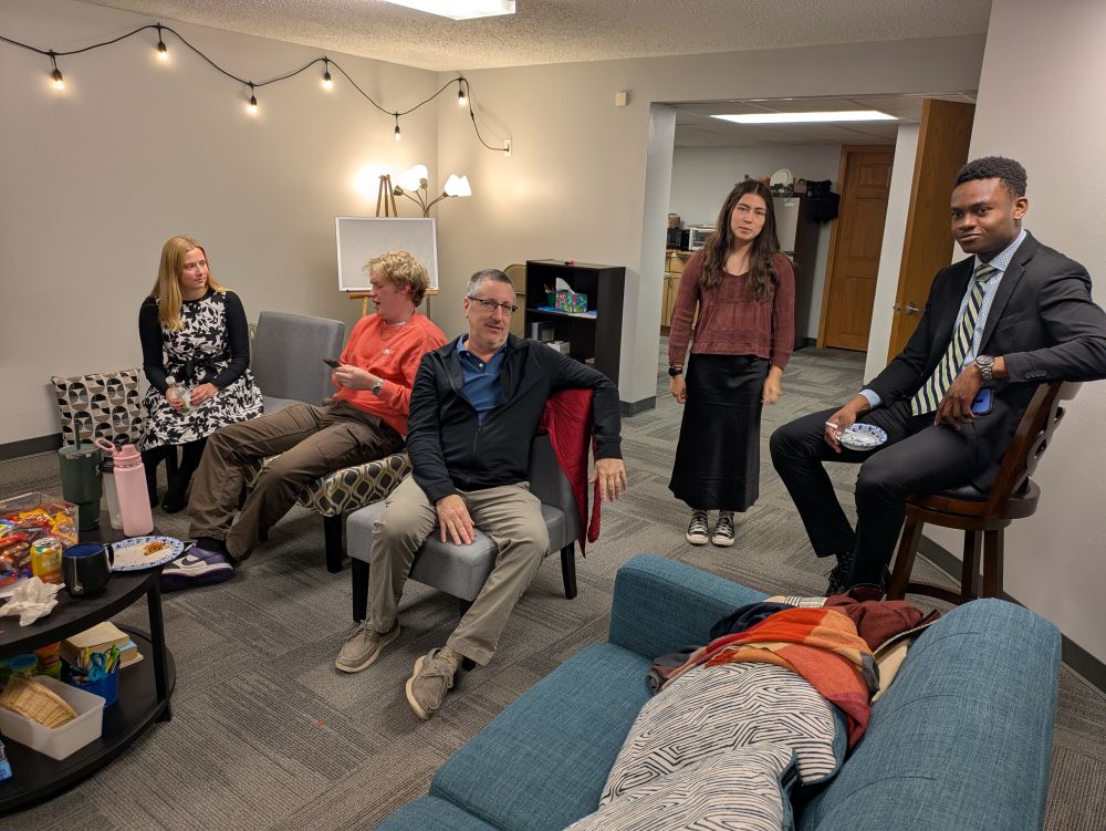 After Church Lunch Fun College age young adults playing a card game in a community space on campus.